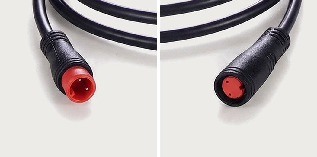 Close-ups of a 2-pin round waterproof plug: male plug with two pins on the left, female plug with two sockets on the right