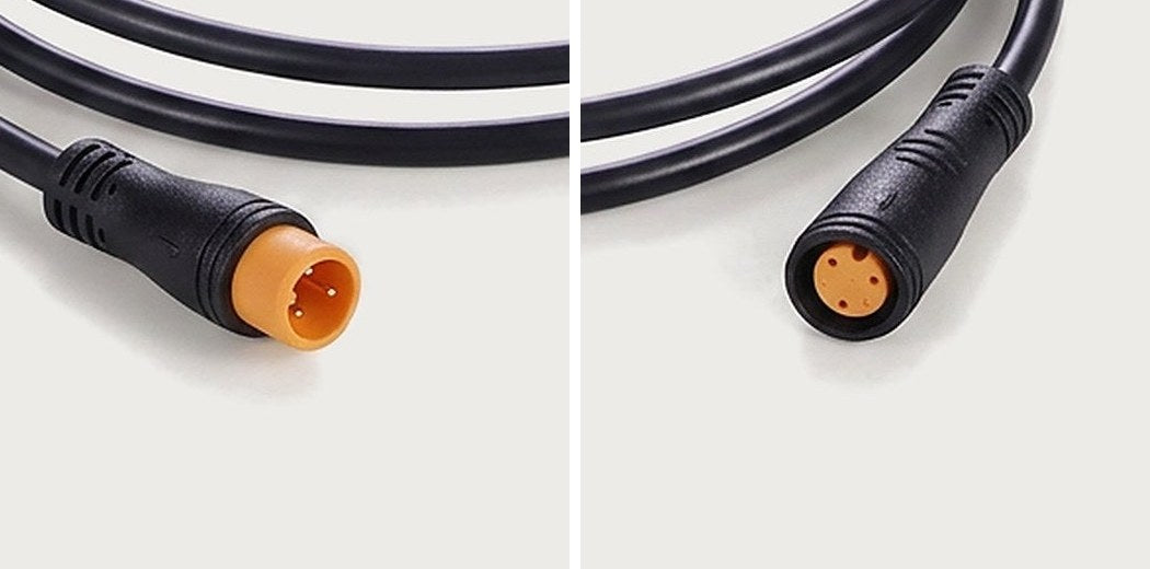 Close-ups of a 3-pin round waterproof plug: male plug with three pins on the left, female plug with three sockets on the right