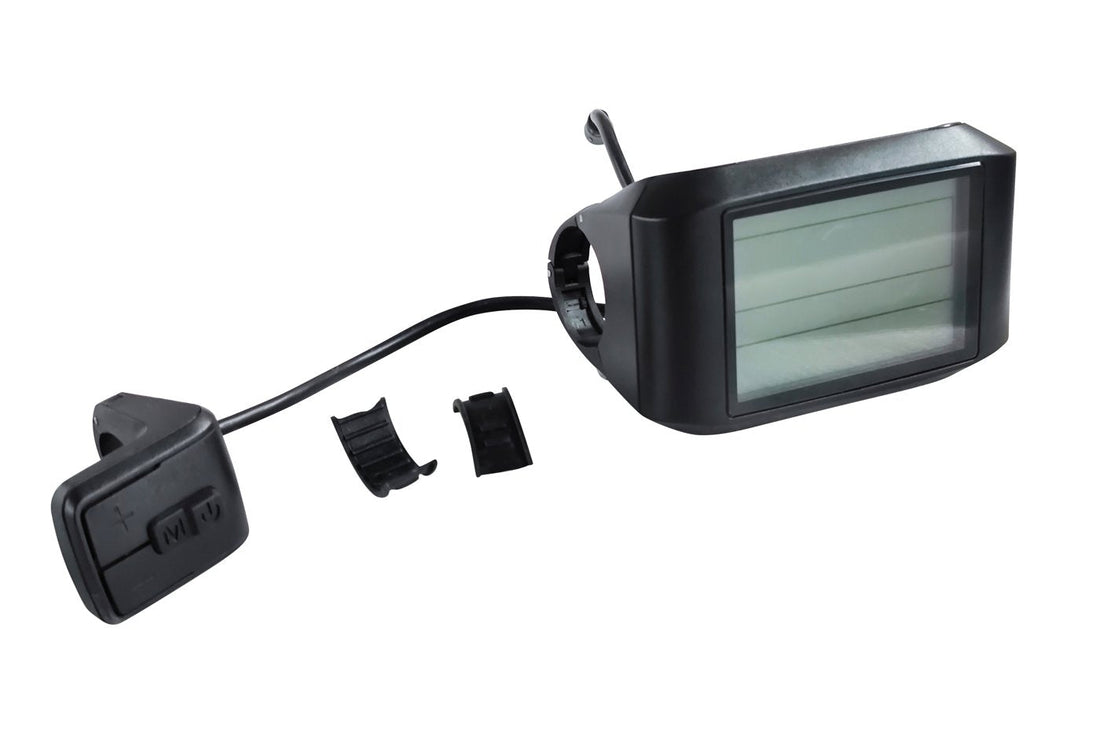 A black e-bike LCD display on a white background, shown with its separate three-button control pad marked plus, M and power joined by a black cable, plus two small black rubber handlebar shims; the rectangular screen is unlit