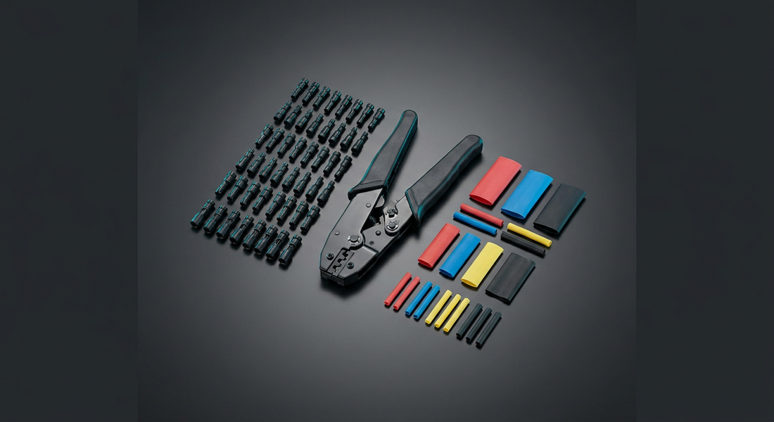 Waterproof connector crimping kit on grey: rows of small black bullet connectors with teal inserts, a black-and-green crimping plier at centre, plus red, blue, yellow and black heat-shrink tubing in assorted lengths.