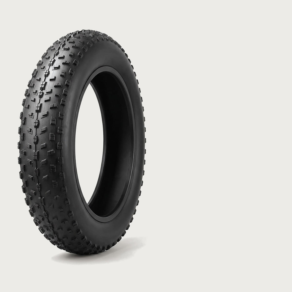 Black fat bike tire with an open, aggressive knobby tread