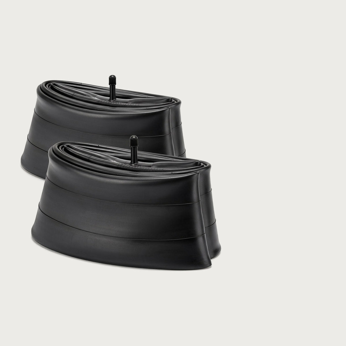 Two black fat bike inner tubes with Schrader valve stems