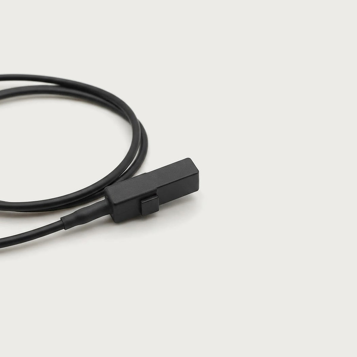 Close-up of the small black connector plug on the sensor cable