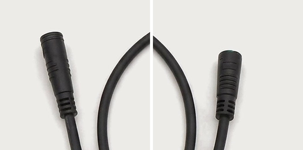 Two slim black round 5-pin display plugs